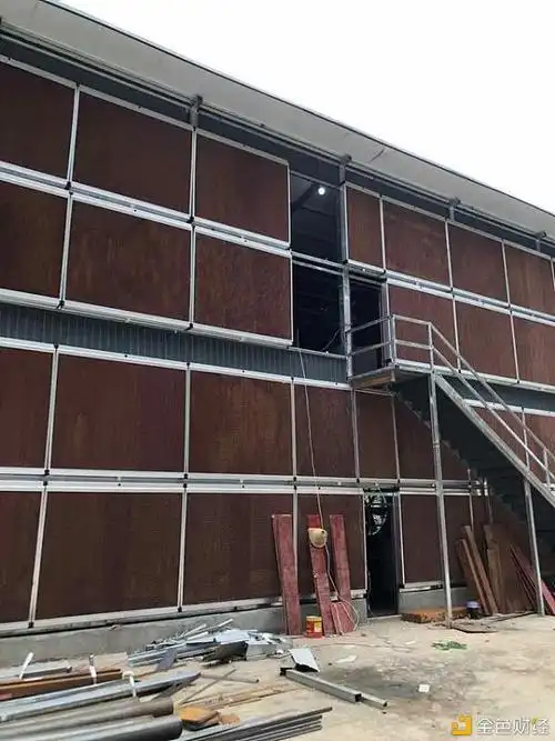 A large-scale mining farm with rows of mining rigs, showcasing the industrial nature and scale of modern cryptocurrency mining operations.